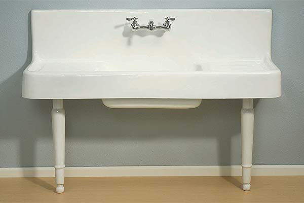 Cast iron front apron kitchen sink with drainboard