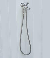Outdoor shower handspray mounted on wall