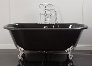 Clawfoot bathtub with deck mounted faucet and handshower